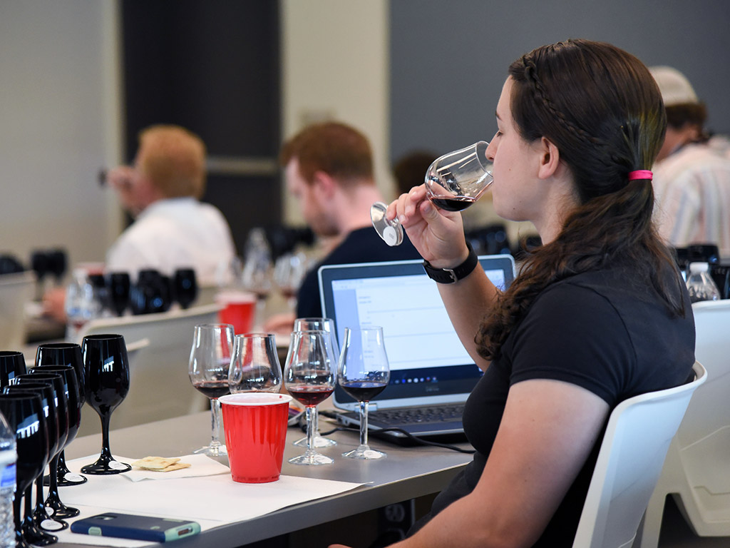 Student Sampling Wine in Enology Class